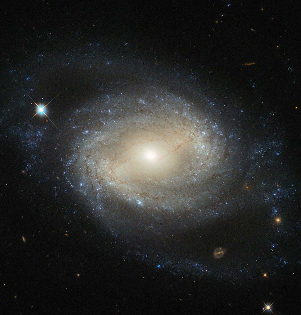NGC4639 Galaxy - This is known as an active galactic nucleus (AGN), and is revealed by characteristic features in the spectrum of light from the galaxy and by X-rays produced close to the black hole as the hot gas plunges towards it.